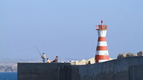 Fishermen near the lighthouse Stock Footage 114610165
