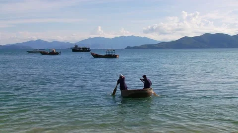 Fishermen paddling in coracle Stock Footage 54591579