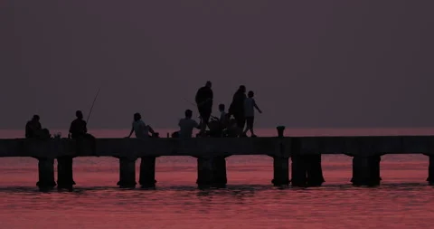 Fishermen on the pier at dusk Stock Footage 270149343