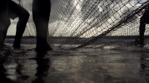 Fishermen preparing net at beach in slowmotion Stock Footage 68083842