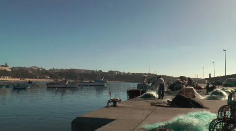 Fishermen preparing net in sines harbor, portugal wide angle shot Stock Footage 33779344