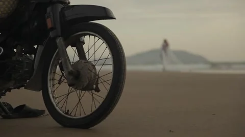 Fishermen is pulling a fishing net from the sea (motorbike in the foreground). Stock Footage 42884789