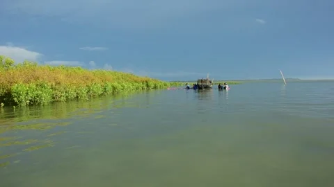 Fishermen Pulling Large Fishing Net in River During High Tide Stock Footage 319461826