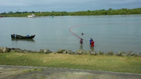 Fishermen Pulling Large Fishing Net in River During High Tide Stock Footage 319462384