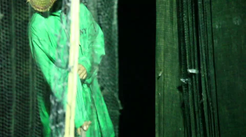 Fishermen pulling large net, hitting fish back into net 스톡 동영상 33131129