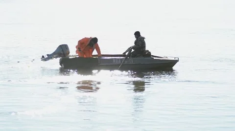 Fishermen put the net from the boat. Stock Footage 46615055