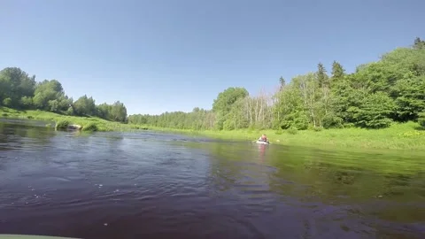 Fishermen raft down the river in an inflatable rubber boat Stock Footage 156702434