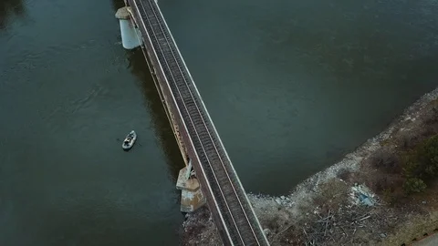 Fishermen on a raft float down a river and pass under a bridge Video stock 125228883