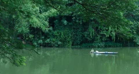 Fishermen rowing in the river Stock Photos