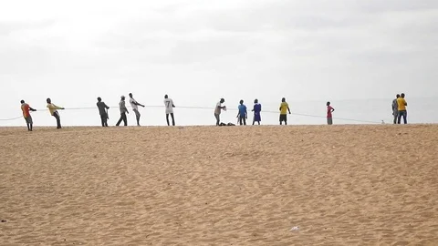 Fishermen sing and pull net out of the sea Stock Footage 81093875