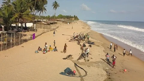 Fishermen sorting out their net on the beach Stock Footage 91460546