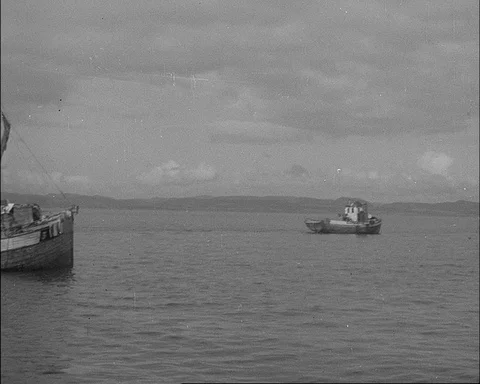 Fishermen stop their boats while plotting against German opressors, Norway 1943 Stock Footage 141061788