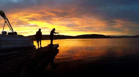 Fishermen at sunset on a lake Stock Footage 51797293