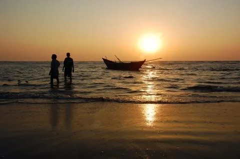 Fishermen at sunset Stock Photos