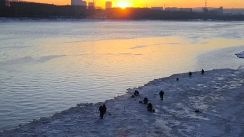 Fishermen at sunset in winter Stock Footage 73897446