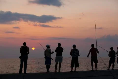 Fishermen trying their luck, standing on the railing of the Malecon in Havana, Stock Photos