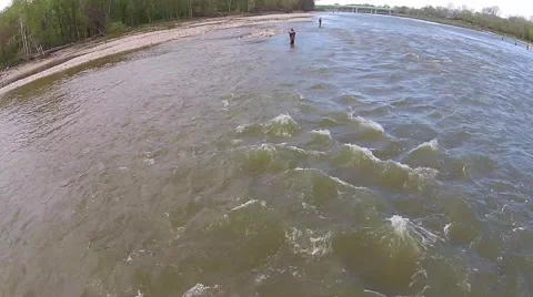 Fishermen wading in the river as the water flows by Stock Footage 40340409