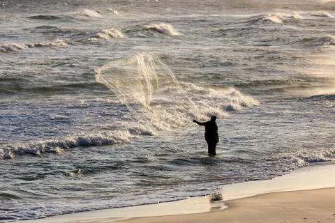 Fishermen at work during sunset Stock Photos