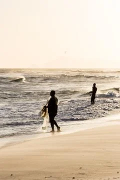 Fishermen at work during sunset Stock Photos