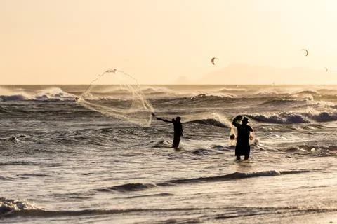 Fishermen at work during sunset Stock Photos