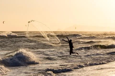 Fishermen at work during sunset Stock Photos