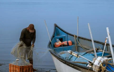 Fishermen at work, pulling the nets Stock Photos