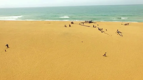Fishermen working on their fish net on Cotonou beach Stock Footage 81075298
