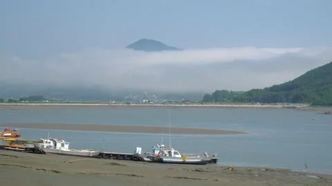 Fisher's boats stuck in the mud on low tide at Ganghwado island in South Stock Footage 155854201