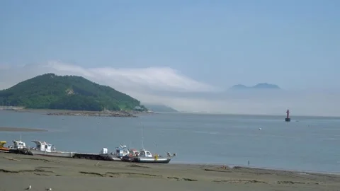 Fisher's boats stuck in the mud on low tide at Ganghwado island in South Stock Footage 155859292