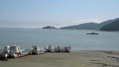 Fisher's boats stuck in the mud on low tide at Ganghwado island in South Stock Footage 155859365
