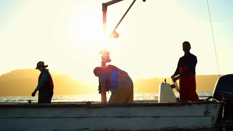 Fishers on their boat at sunset. 動画素材 88372447