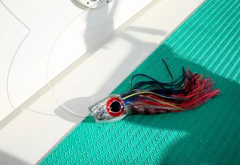 Fishing artificial bait, dummy squid on the background of the fishing boat Ma Stock Photos