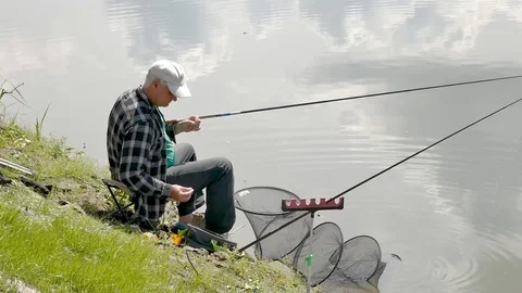Fishing on the bank of the river throws a bait on the hook Stock Footage 108443255
