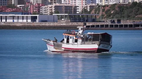 Fishing boat arriving harbor Stock Footage