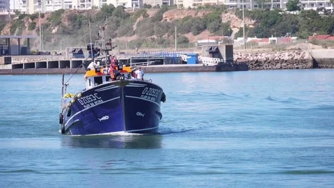 Fishing boat arriving harbor slow motion Stock Footage