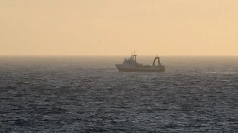 Fishing Boat Battling Rough Waves in Atlantic Ocean at Dramatic Sunset Stock Footage 205038972