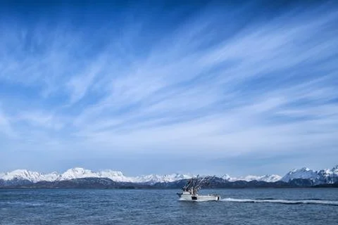 Fishing boat with cloud patterns Stock Photos