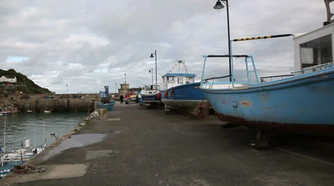 Fishing boat dry dock pan to reveal harbour Stock Footage 33986429