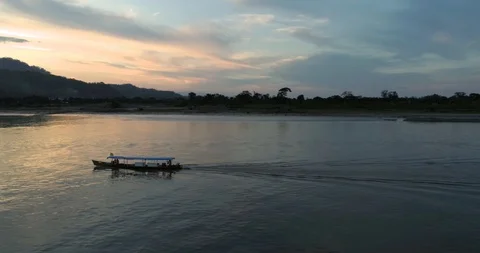 Fishing boat during sunset on the amazon river by drone Stock Footage 98792394
