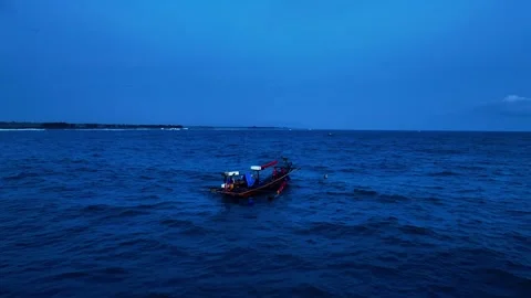 Fishing boat floating on deep blue evening sea Stock Footage 335440926