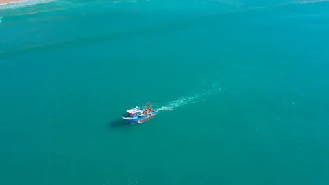 Fishing Boat Floating on Ocean Waves Near Shore Stock Footage 105197128