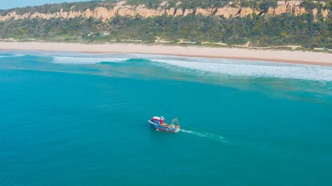 Fishing Boat Floating on Ocean Waves Near Shore Stock Footage 105197379