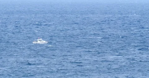 Fishing boat floating on ocean waves big blue water medium shot Stock Footage 213132261