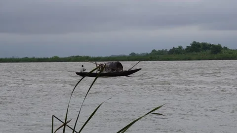A fishing boat is floating on the river Stock Footage 316246342