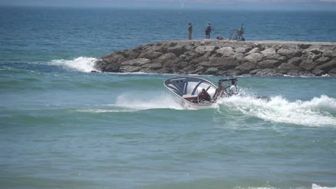 Fishing boat going through beach waves Stock Footage 138251262