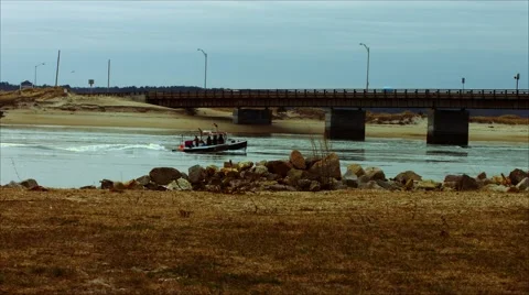Fishing Boat going Under Bridge at Beach During The Winter Stock Footage 45373797