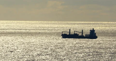 Fishing boat on the horizon in the backlight, 4k Stock Footage 239759684