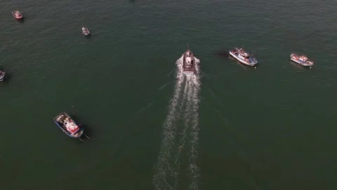 A fishing boat moors into the harbor as seen from above. Aerial view of a vessel Stock Footage 237119331