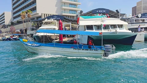 Fishing boat navigating the vibrant marina in Cabo San Lucas, Baja California Stock Footage 329645595