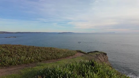 Fishing boat in the Pacific Ocean off the cliffs of Bodega Head Stock Footage 327497406